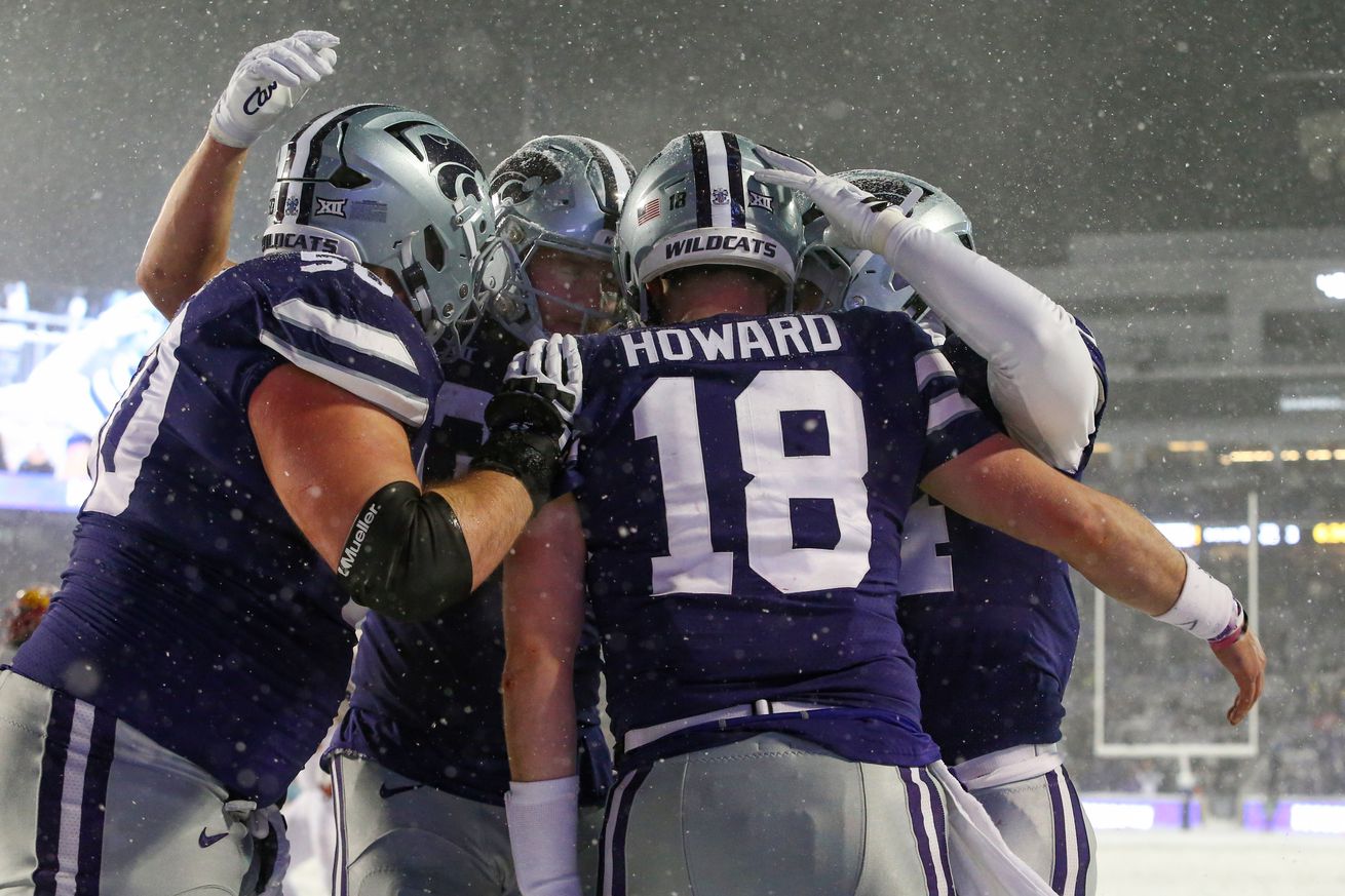 Nov 25, 2023; Manhattan, Kansas, USA; Kansas State Wildcats quarterback Will Howard (18) is congratulated by teammates after scoring a touchdown in the third quarter against the Iowa State Cyclones at Bill Snyder Family Football Stadium. Mandatory Credit: Scott Sewell