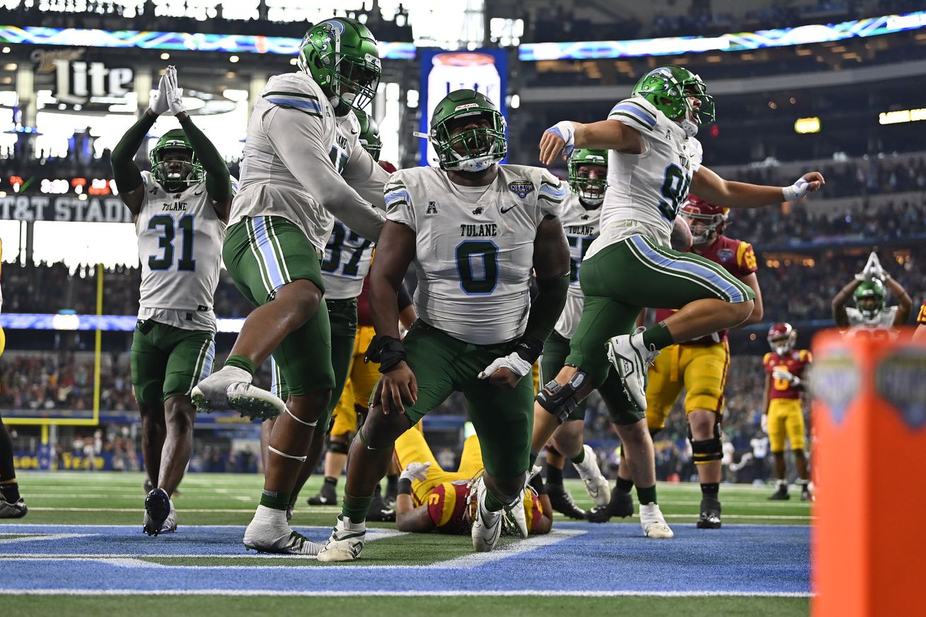 ARLINGTON, TEXAS - JANUARY 02: Defensive lineman Patrick Jenkins #0 of the Tulane Green Wave celebrates after tackling running back Austin Jones #6 of the USC Trojans in the end zone for a safety during the fourth quarter of the Goodyear Cotton Bowl Classic football game at AT&T Stadium on January 02, 2023 in Arlington, Texas. The Tulane Green Wave won 46-45.