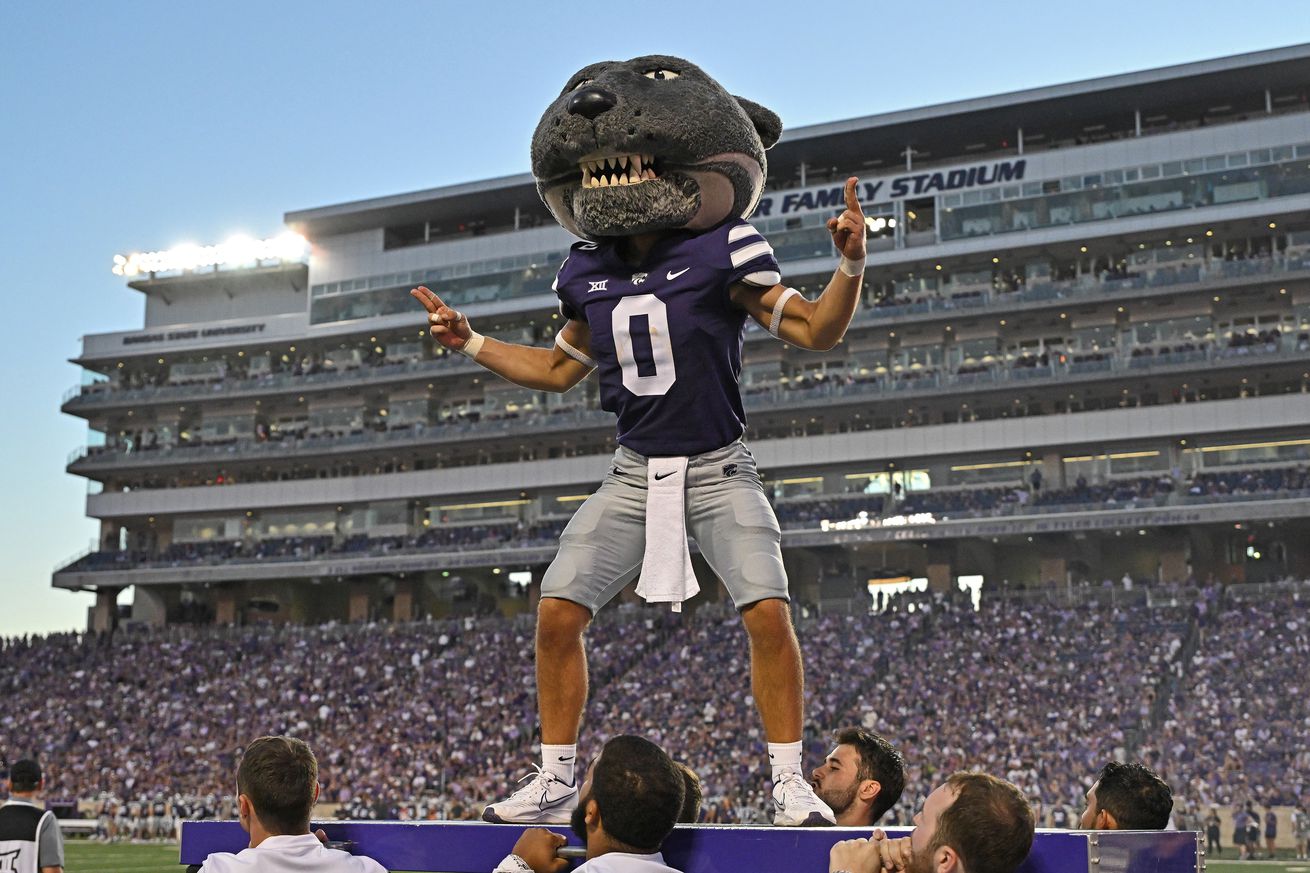 Kansas State’s Willie Wildcat stands on a platform with the press box of Bill Snyder Family Stadium in the background.