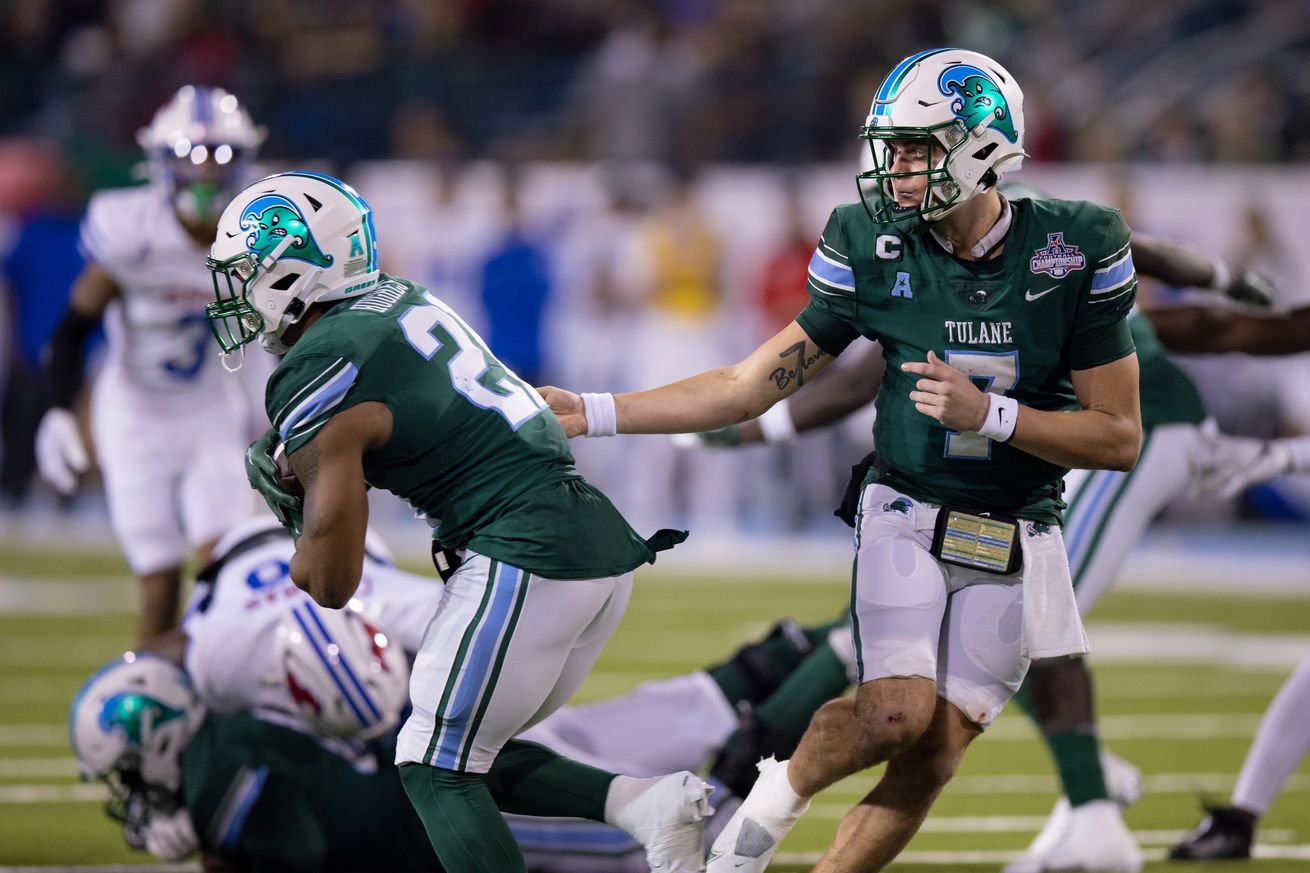 Dec 2, 2023; New Orleans, LA, USA; Tulane Green Wave quarterback Michael Pratt (7) hands the ball off against the Southern Methodist Mustangs during the second half at Yulman Stadium.