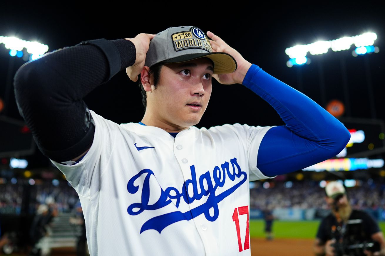 Shohei Ohtani #17 of the Los Angeles Dodgers puts a hat on to celebrate advancing to the World Series after winning Game 6 of the NLCS