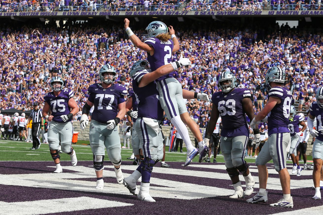  Sep 28, 2024; Manhattan, Kansas, USA; Kansas State Wildcats quarterback Avery Johnson (2) leaps into the arms of offensive lineman Hadley Panzer (54) after scoring a touchdown against the Oklahoma State Cowboys in the fourth quarter at Bill Snyder Family Football Stadium.