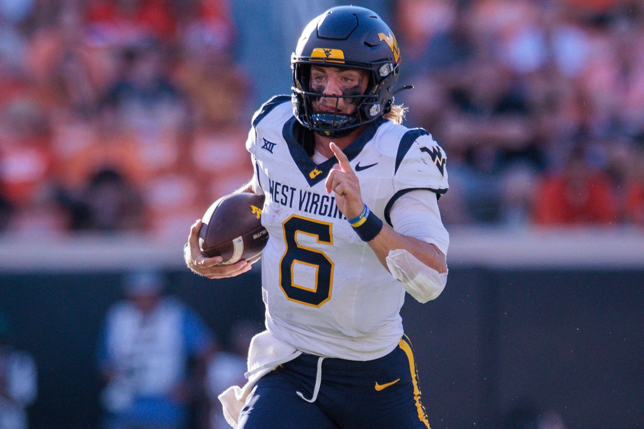 Oct 5, 2024; Stillwater, Oklahoma, USA; West Virginia Mountaineers quarterback Garrett Greene (6) runs the ball against the Oklahoma State Cowboys during the fourth quarter at Boone Pickens Stadium.