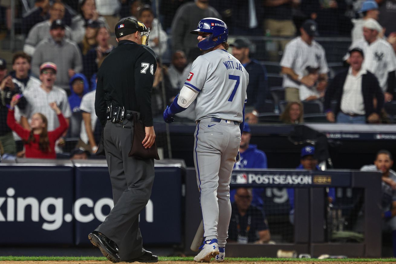 Kansas City Royals shortstop Bobby Witt Jr. (7) talks with umpire Adam Hamari (78) after striking out during the ninth inning against the New York Yankees during game one of the ALDS for the 2024 MLB Playoffs at Yankee Stadium.