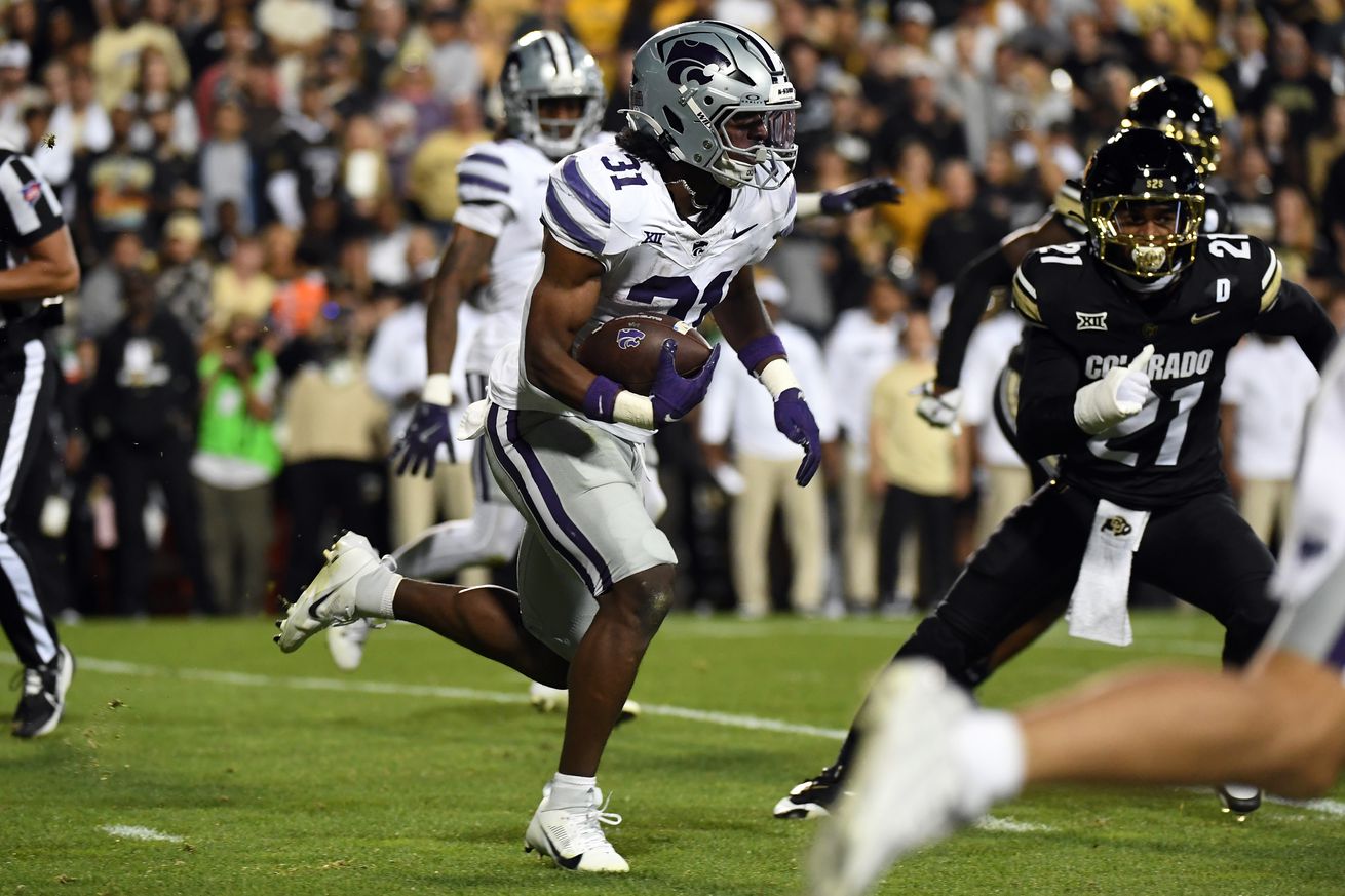 Oct 12, 2024; Boulder, Colorado, USA; Kansas State Wildcats running back DJ Giddens (31) runs for a first down during the first half against the Colorado Buffaloes at Folsom Field.