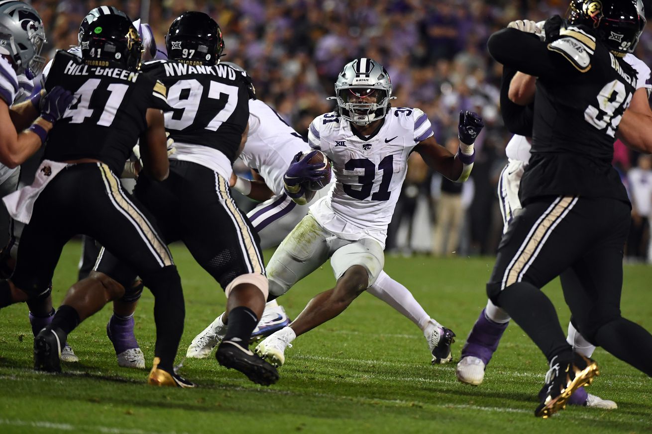 Oct 12, 2024; Boulder, Colorado, USA; Kansas State Wildcats running back DJ Giddens (31) runs for a short gain during the second half against the Colorado Buffaloes at Folsom Field.