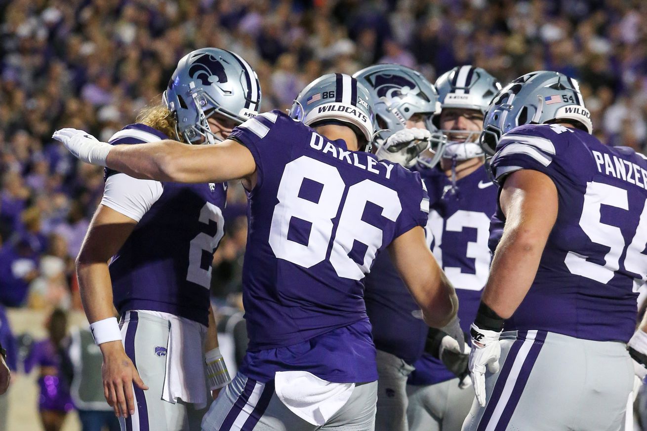 Oct 26, 2024; Manhattan, Kansas, USA; Kansas State Wildcats tight end Garrett Oakley (86) is congratulated by teammates after scoring a touchdown in the second quarter against the Kansas Jayhawks at Bill Snyder Family Football Stadium.