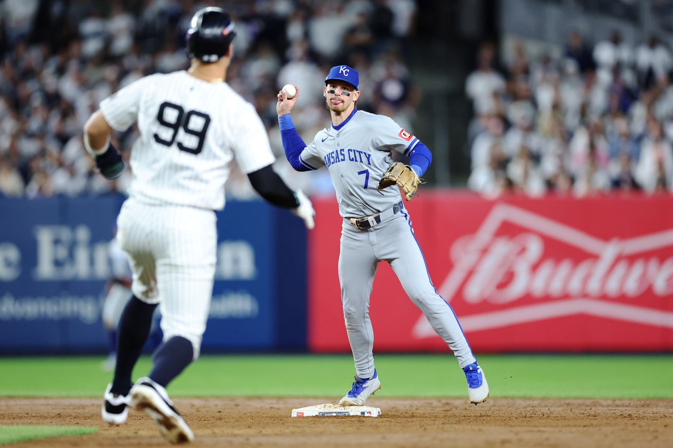 Bobby Witt Jr. #7 of the Kansas City Royals turns a double play in the fifth inning against Aaron Judge #99 of the New York Yankees during Game Two of the Division Series at Yankee Stadium on October 07, 2024 in New York City.