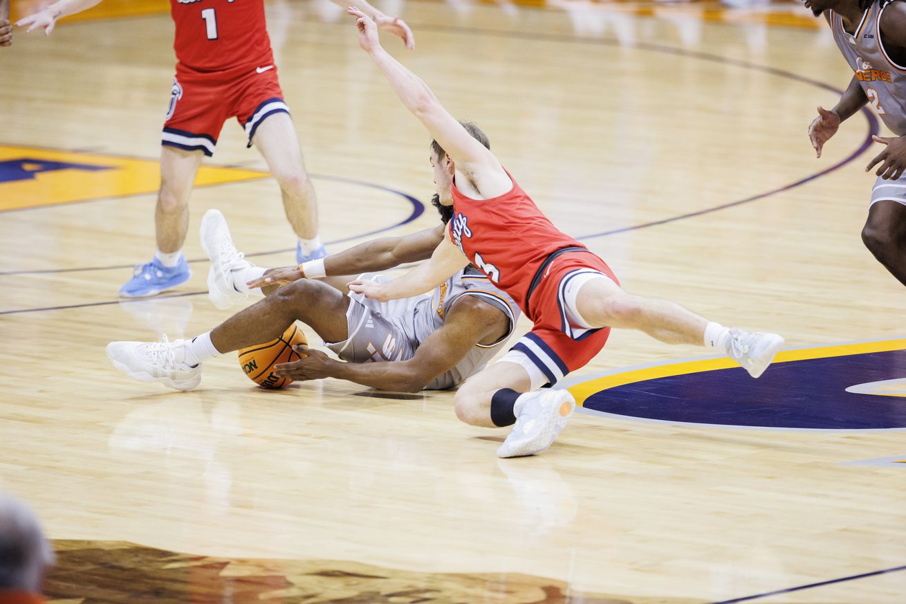 Feb 3, 2024; El Paso, Texas, USA; UTEP Miners guard Otis Frazier III (23) and Liberty University Flames guard Kaden Metheny (3) battle for a loose ball in the second half at Don Haskins Center.