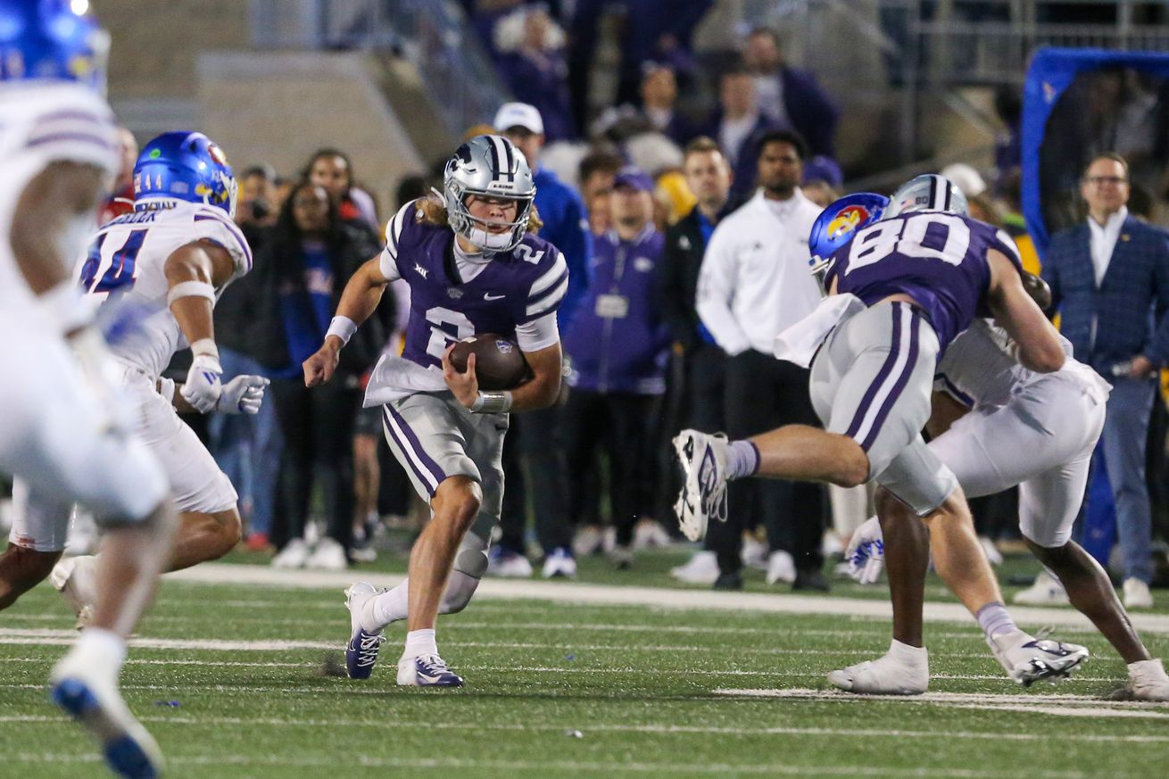 Oct 26, 2024; Manhattan, Kansas, USA; Kansas State Wildcats quarterback Avery Johnson (2) looks for room to run against the Kansas Jayhawks in the fourth quarter at Bill Snyder Family Football Stadium.