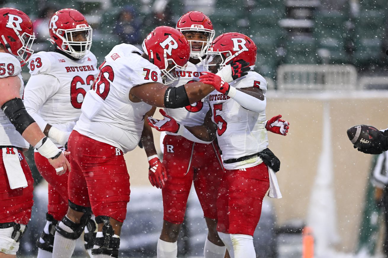 EAST LANSING, MI - NOVEMBER 30: Rutgers Scarlet Knights running back Kyle Monangai (5) celebrates a first quarter touchdown with his teammates during a college football game between the Michigan State Spartans and Rutgers Scarlet Knights on November 30, 2024 at the Breslin Center in East Lansing, MI.