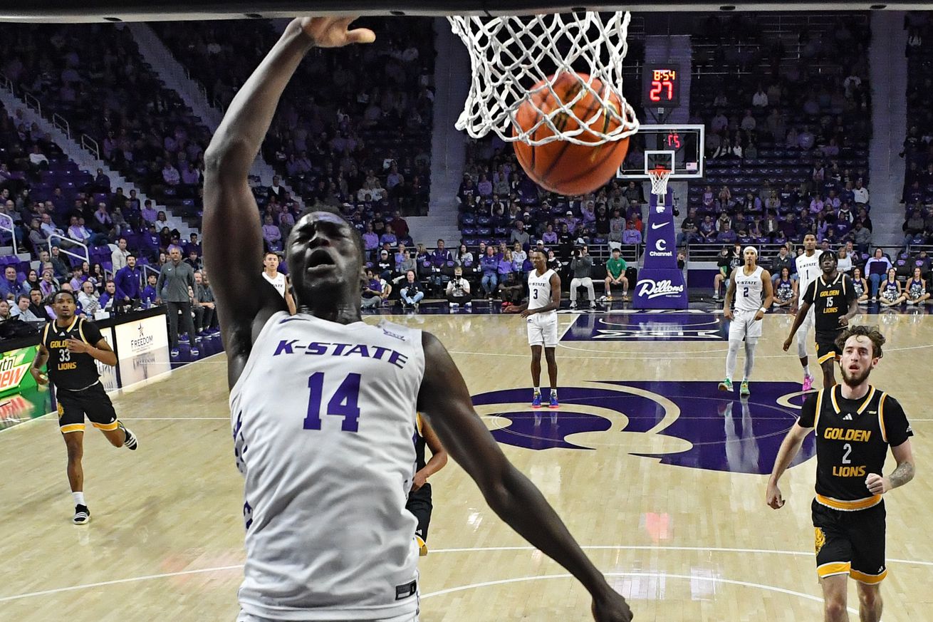 MANHATTAN, KS - DECEMBER 01: Achor Achor #14 of the Kansas State Wildcats scores with a dunk in the first half against the Arkansas-Pine Bluff Golden Lions at Bramlage Coliseum on December 1, 2024 in Manhattan, Kansas.