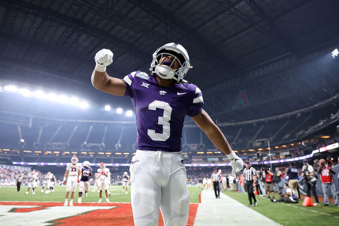 PHOENIX, ARIZONA - DECEMBER 26: Running back Dylan Edwards #3 of the Kansas State Wildcats reacts after scoring the go ahead touchdown during the second half of the Rate Bowl against the Rutgers Scarlet Knights at Chase Field on December 26, 2024 in Phoenix, Arizona.