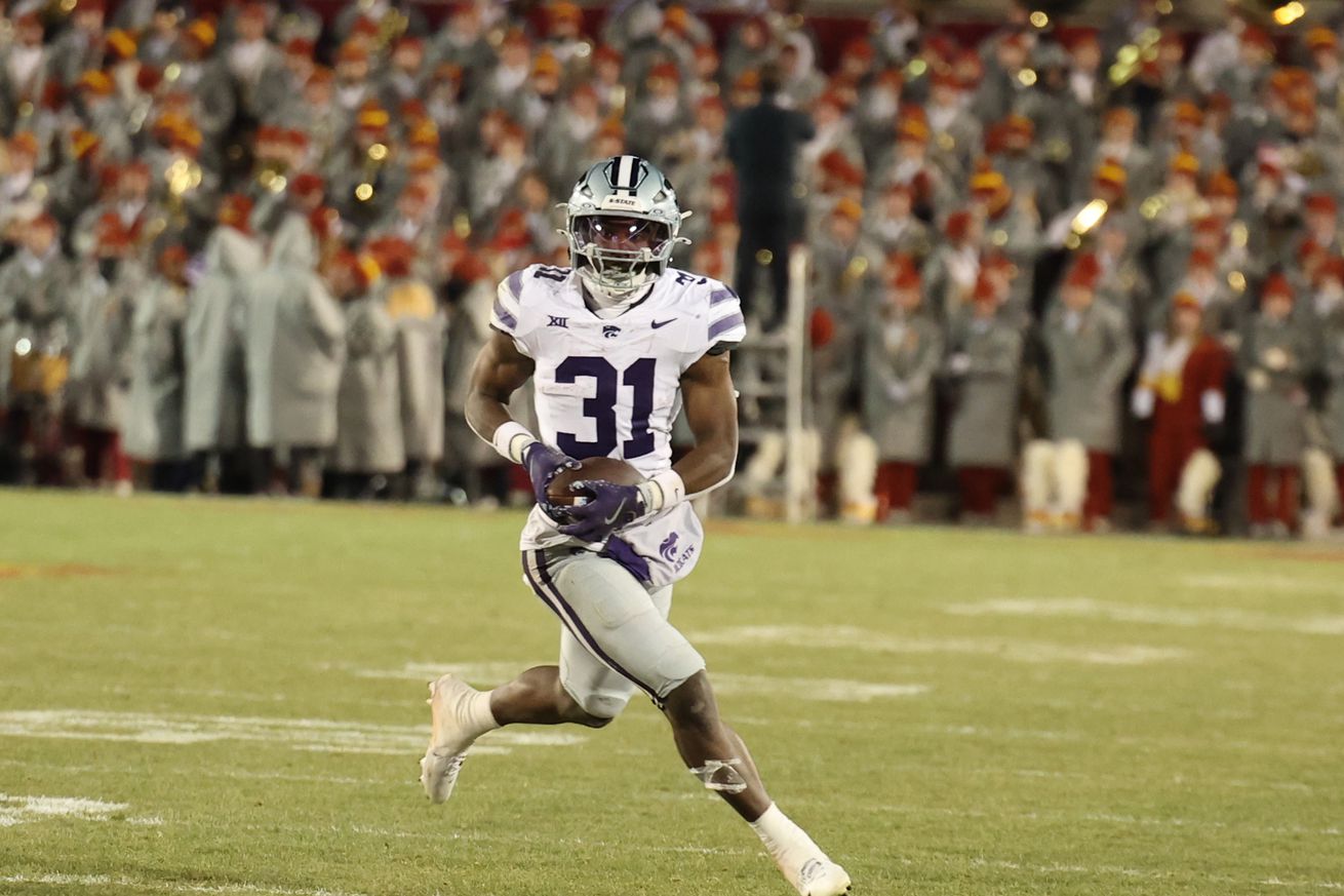 Nov 30, 2024; Ames, Iowa, USA; Kansas State Wildcats running back DJ Giddens (31) runs for a first down against the Iowa State Cyclones in the second quarter at at Jack Trice Stadium.