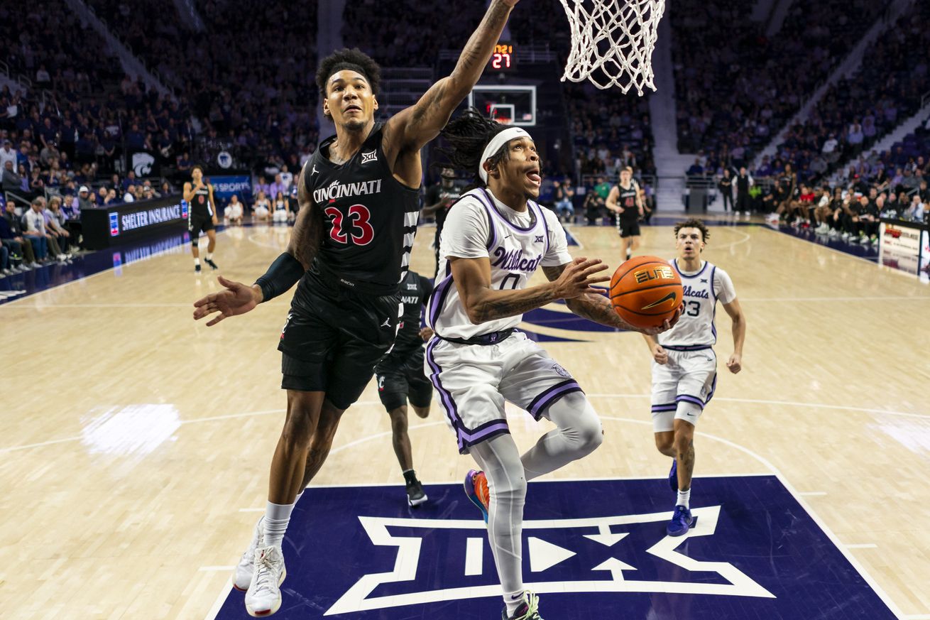 Background: Dec 30, 2024; Manhattan, Kansas, USA; Kansas State Wildcats guard Dug McDaniel (0) shoots against Cincinnati Bearcats forward Dillon Mitchell (23) during the second half at Bramlage Coliseum. Mandatory Credit: Jay Biggerstaff-Imagn Images      