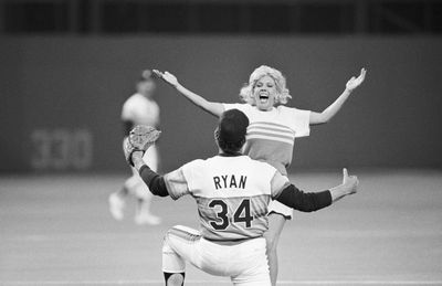 Nolan Ryan About To Hug Woman On Field