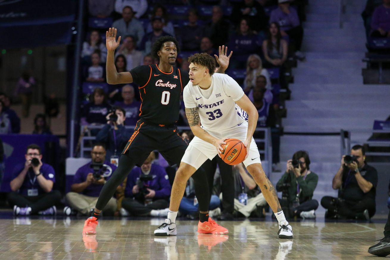 Jan 29, 2025; Manhattan, Kansas, USA; Kansas State Wildcats forward Coleman Hawkins (33) is guarded by Oklahoma State Cowboys forward Marchelus Avery (0) during the first half at Bramlage Coliseum. Mandatory Credit: Scott Sewell-Imagn Images