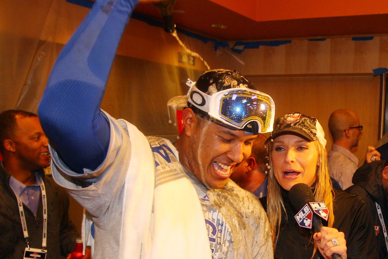 Kansas City Royals catcher Salvador Perez dumps champagne on his head in the clubhouse after defeating the New York Mets to win game five of the World Series at Citi Field.