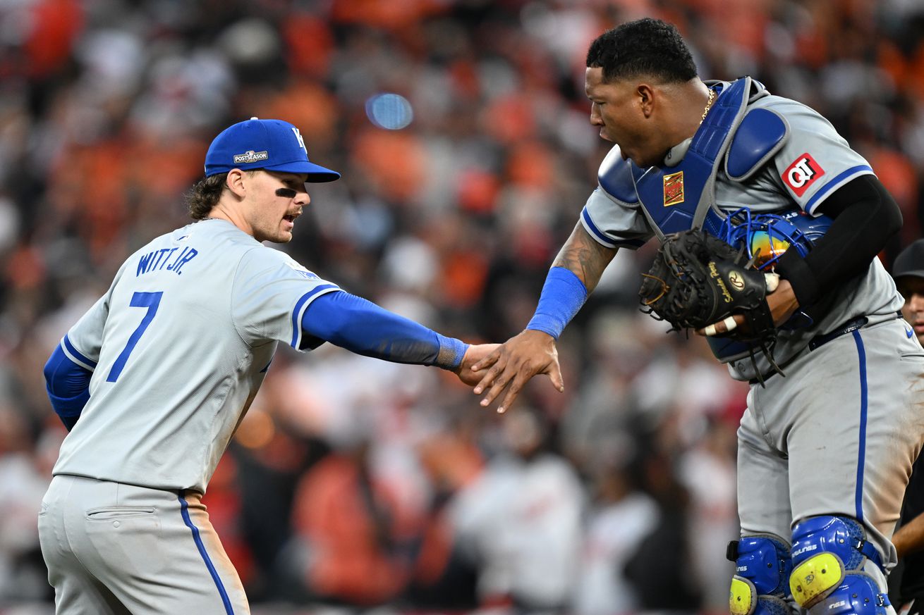 Bobby Witt Jr. #7 and Salvador Perez #13 of the Kansas City Royals celebrate