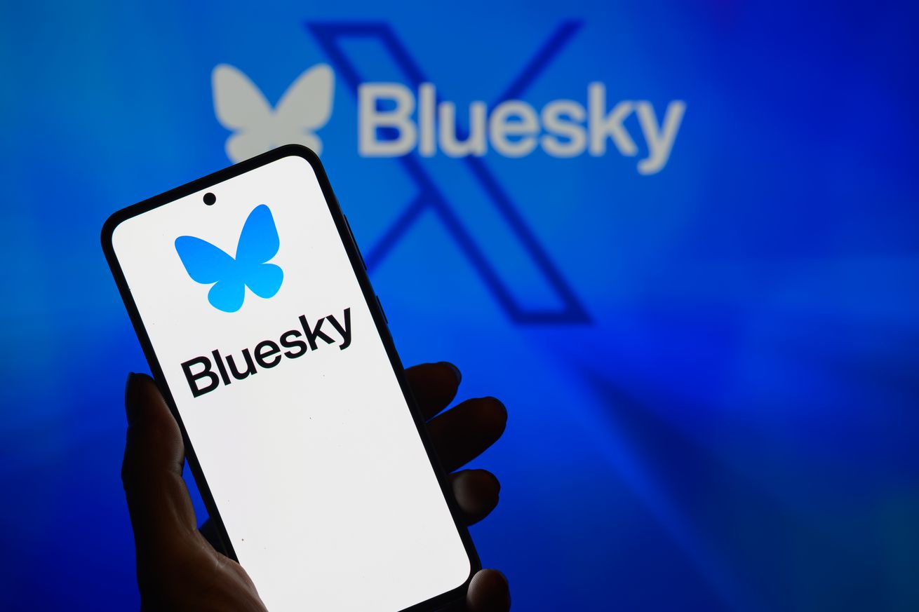 The Bluesky logo appears on a smartphone with Bluesky visible in the background in this photo illustration in Brussels, Belgium, on November 24, 2024.