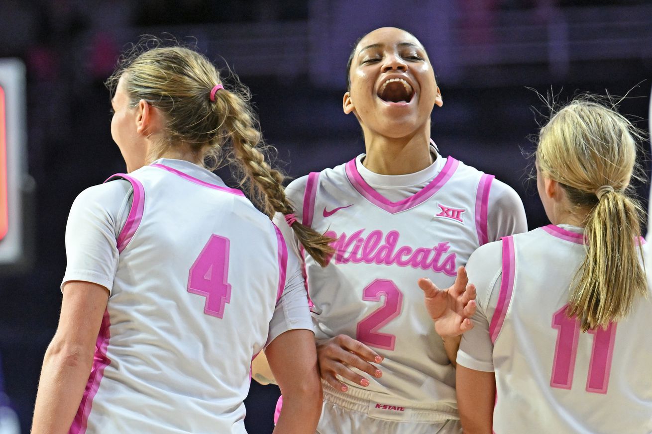 Temira Poindexter #2 of the Kansas State Wildcats and teammates Serena Sundell #4 and Taryn Sides #11 of the Kansas State Wildcats celebrate after beating the TCU Horned Frogs at Bramlage Coliseum on February 5, 2025 in Manhattan, Kansas.