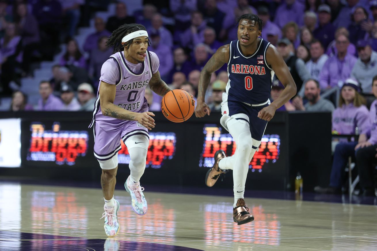 MANHATTAN, KS - FEBRUARY 11: Kansas State Wildcats guard Dug McDaniel (0) leads a fast break ahead of Arizona Wildcats guard Jaden Bradley (0) in the first half of a Big 12 basketball game between the Arizona Wildcats and Kansas State Wildcats on February 11, 2025 at Bramlage Coliseum in Manhattan, KS.