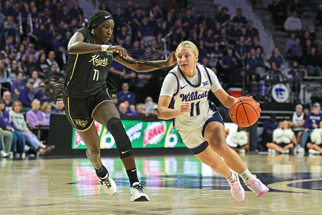 Taryn Sides #11 of the Kansas State Wildcats drives with the ball against Achol Akot #11 of the UCF Knights in the second half at Bramlage Coliseum on February 15, 2025 in Manhattan, Kansas.