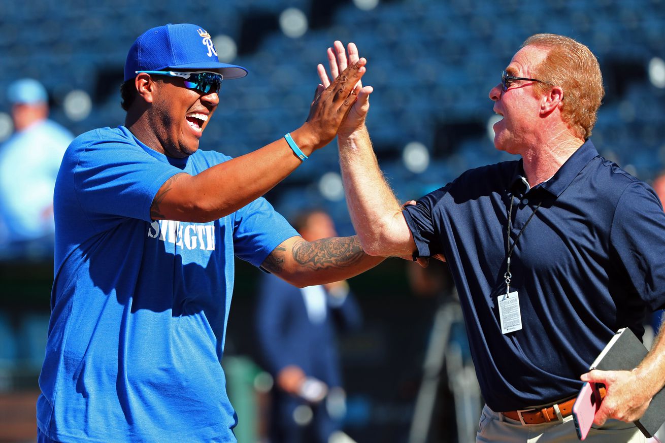 Kansas City, MO, USA; Kansas City Royals catcher Salvador Perez (13) laughs with broadcaster Rex Hudler before the game against the Detroit Tigers at Kauffman Stadium.