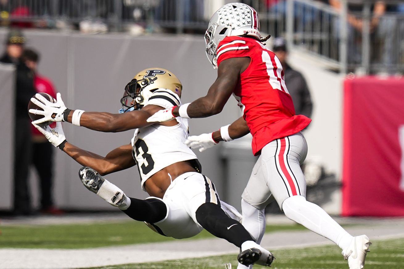 Nov 9, 2024; Columbus, Ohio, USA; Purdue Boilermakers wide receiver Jaron Tibbs (13) catches a pass against Ohio State Buckeyes linebacker C.J. Hicks (11) in the second half at Ohio Stadium. 