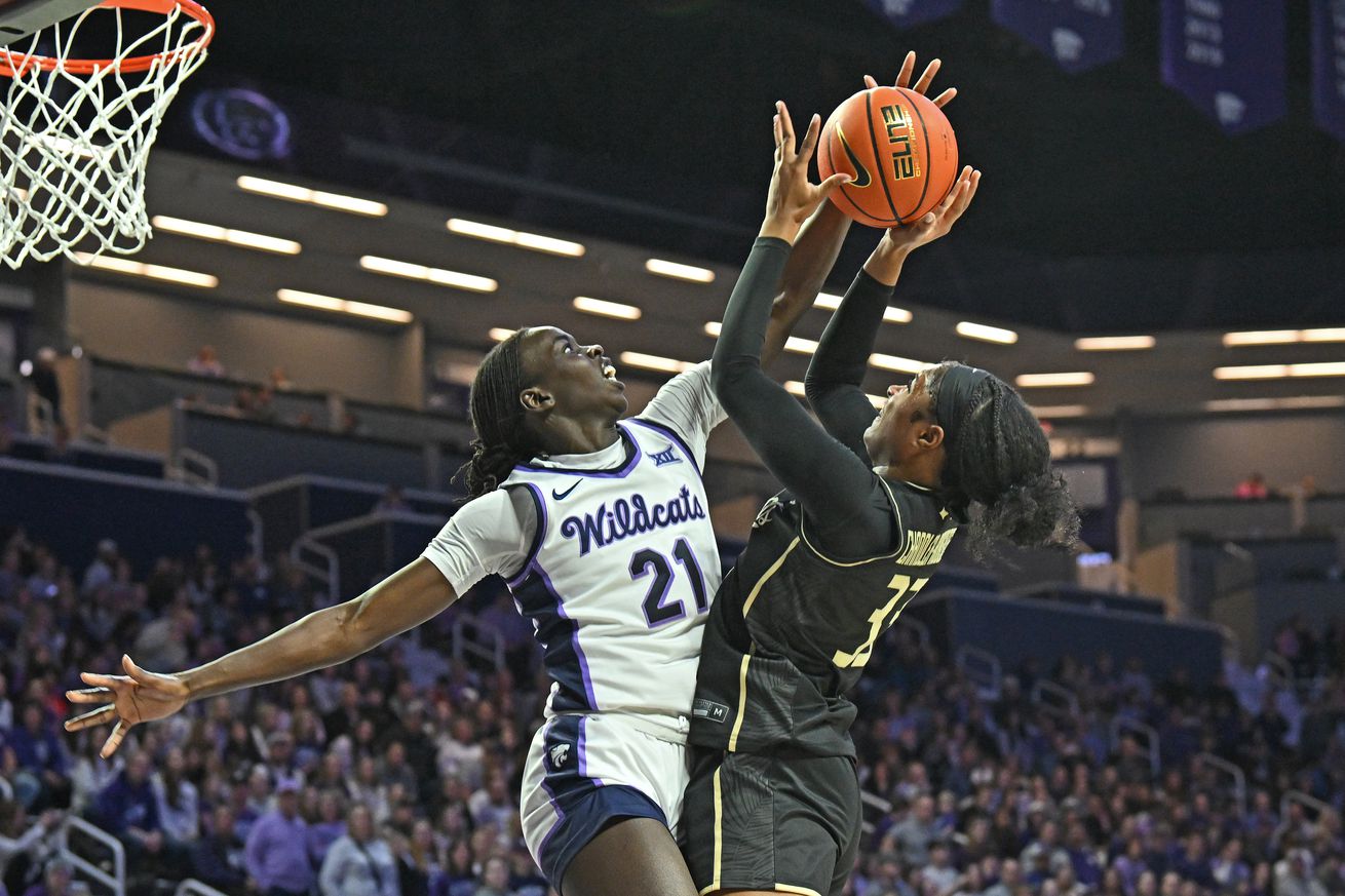 Eliza Maupin #21 of the Kansas State Wildcats defends the shot of Mahogany Chandler-Roberts #33 of the UCF Knights in the second half at Bramlage Coliseum on February 15, 2025 in Manhattan, Kansas.